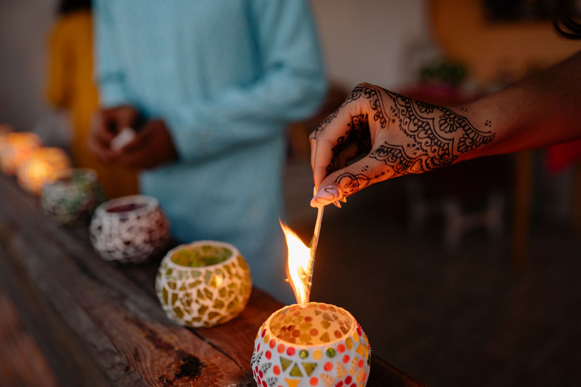 Warm Diwali home interior with a smartphone displaying a three-card game beside diyas and playing cards