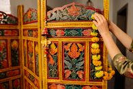 Person Holding Brown Wooden Framed Floral Wall Decor