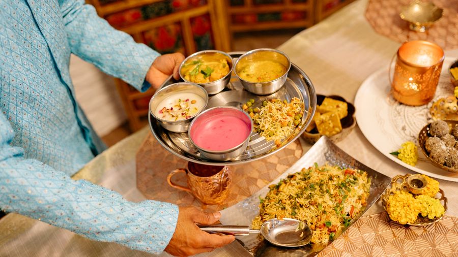 Traditional Indian thali being served for a social event meal in Pune
