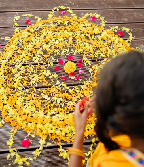 Free A beautiful floral rangoli with yellow and red petals, perfect for Diwali celebrations. Stock Photo