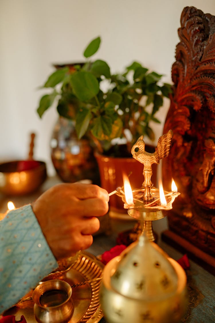 A Hand Lighting The Candle On The Holder 