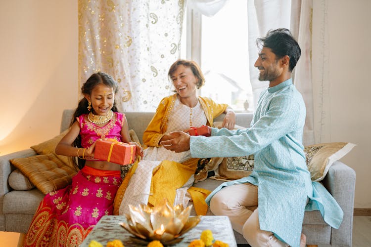 Girl In Pink Sari Receiving A Gift