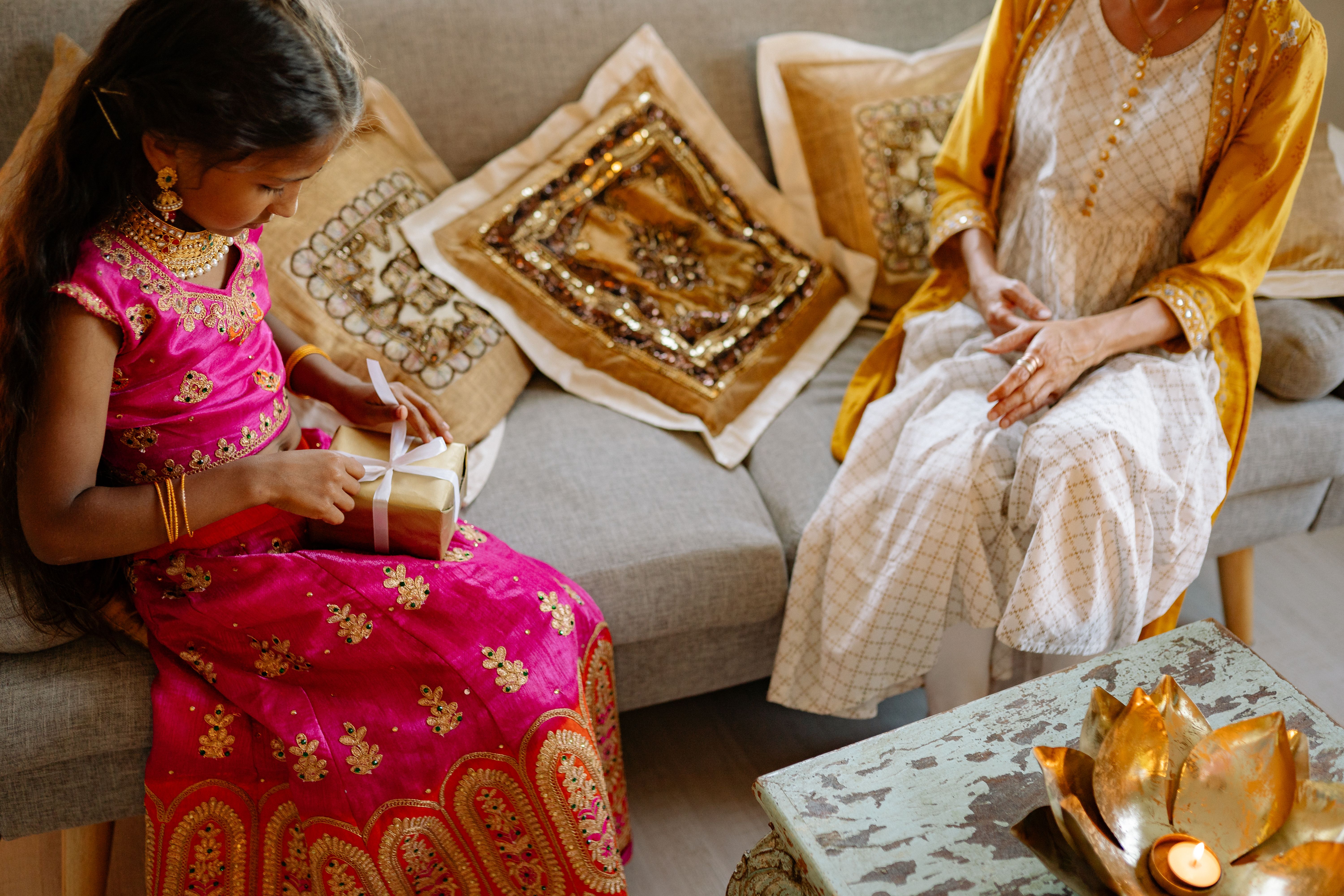 Warm Diwali living room with Indian family playing Teen Patti around a decorated table, diyas glowing