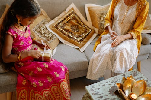 Girl Opening Gift from Mother