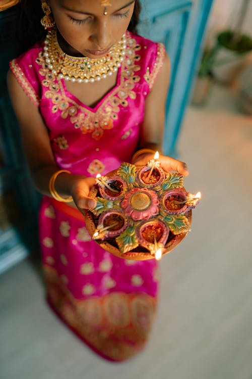 Indian Girl in Traditional Clothing Holding Diwali Candles 