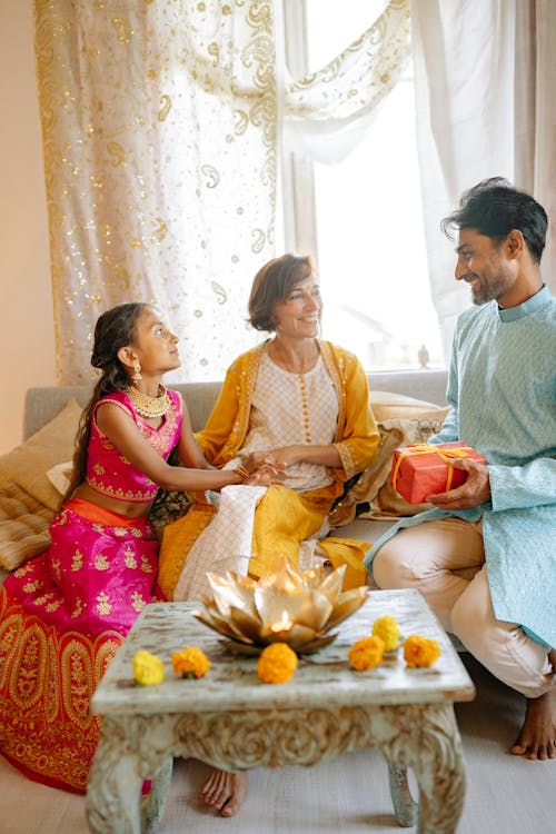 Elegant Dressed Family Sitting on Sofa