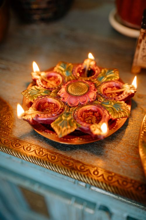 Free Vibrant decorative Diwali lamps lit on a beautifully ornate plate, creating a festive ambiance. Stock Photo