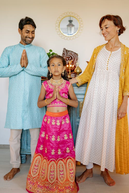 Man and Woman with Girl in Traditional Clothes