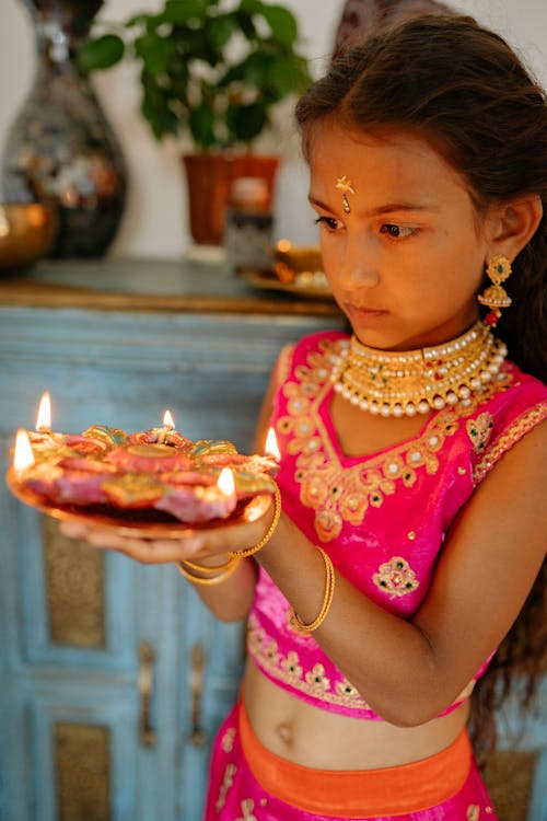 Girl Holding Plate with Burning Candles