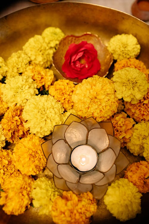 Burning Tealight Candle and Flowers