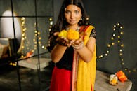 Woman in Red Sleeveless Dress Holding Yellow and Green Fruit