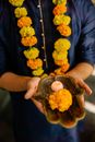 Person Holding Brown Leather Pouch With Yellow Flowers