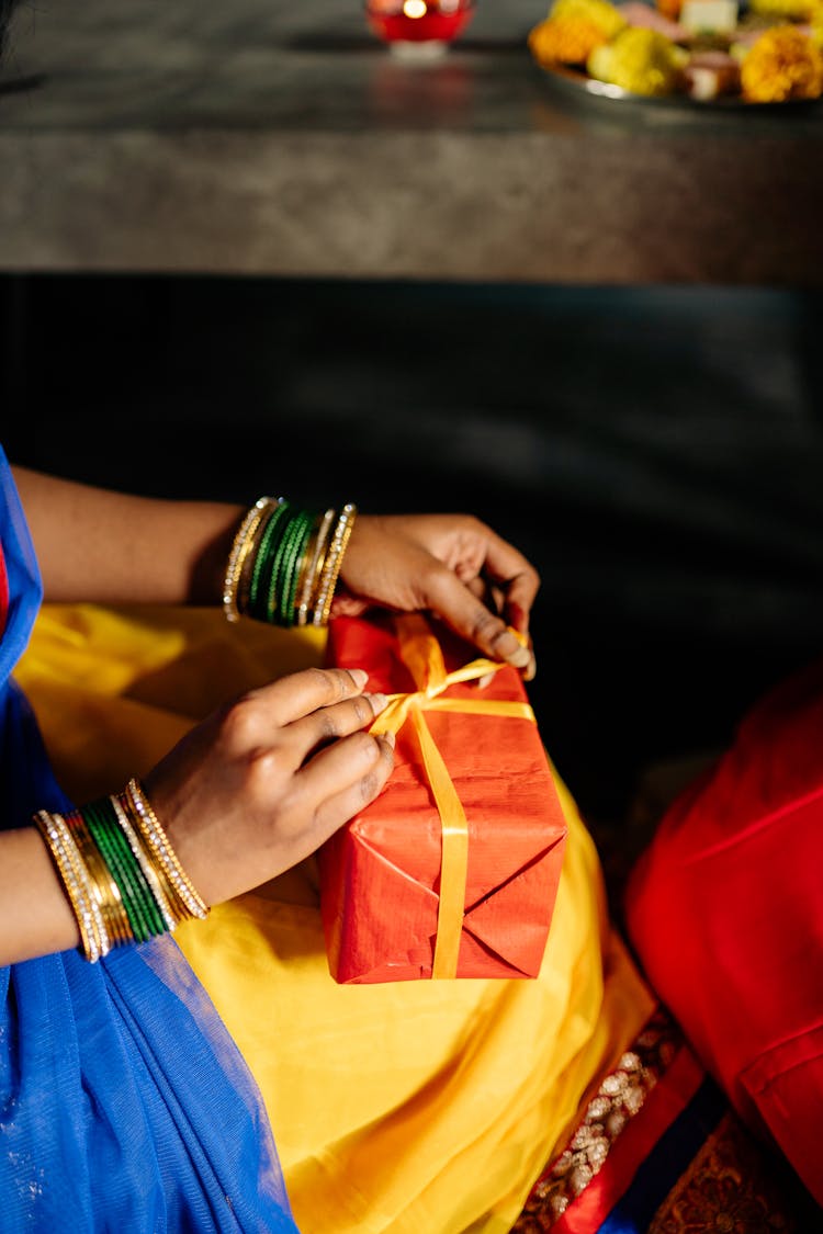 Close Up Of Woman Tying Box