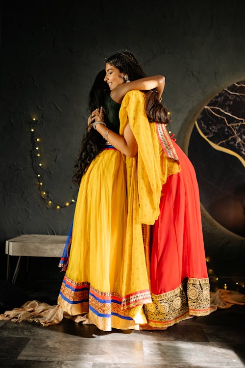 Women in Bright Color Dresses Hugging