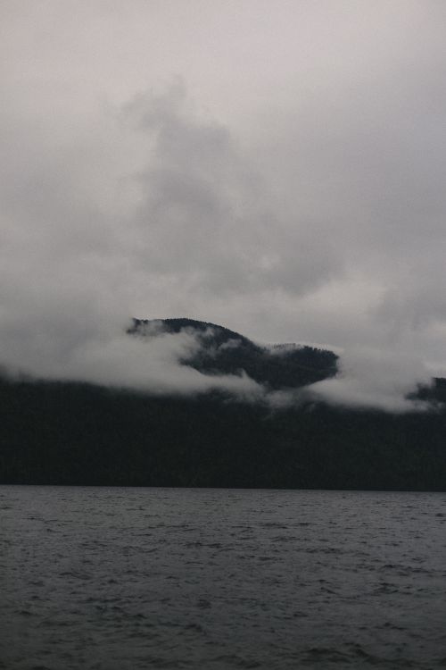 Free Moody mountain view with mist and clouds over a lake in Altai, Russia. Stock Photo