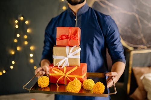Free Man in Blue Long Sleeves Holding Gifts Stock Photo