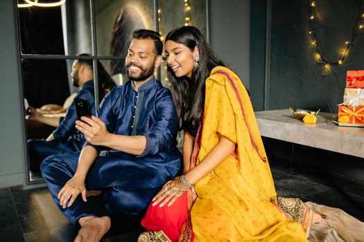 Woman in Yellow Dress Sitting Beside Man in Blue Dress Shirt