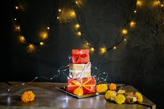 Stacked gift boxes with festive lights and marigolds on a table. Perfect for holiday celebrations.