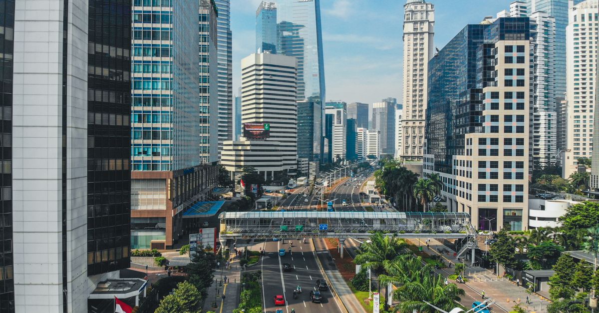 A vibrant aerial view of South Jakarta's urban skyline featuring modern skyscrapers and bustling streets.