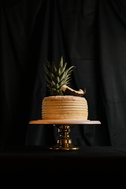 Free Brown and White Round Cake on Black Table Stock Photo