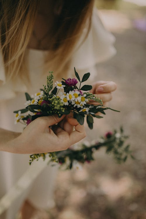 Crop woman with wreath of blooming flowers