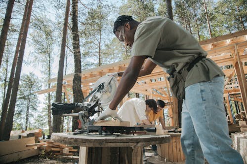 A Man Cutting Wood Using Circular Saw