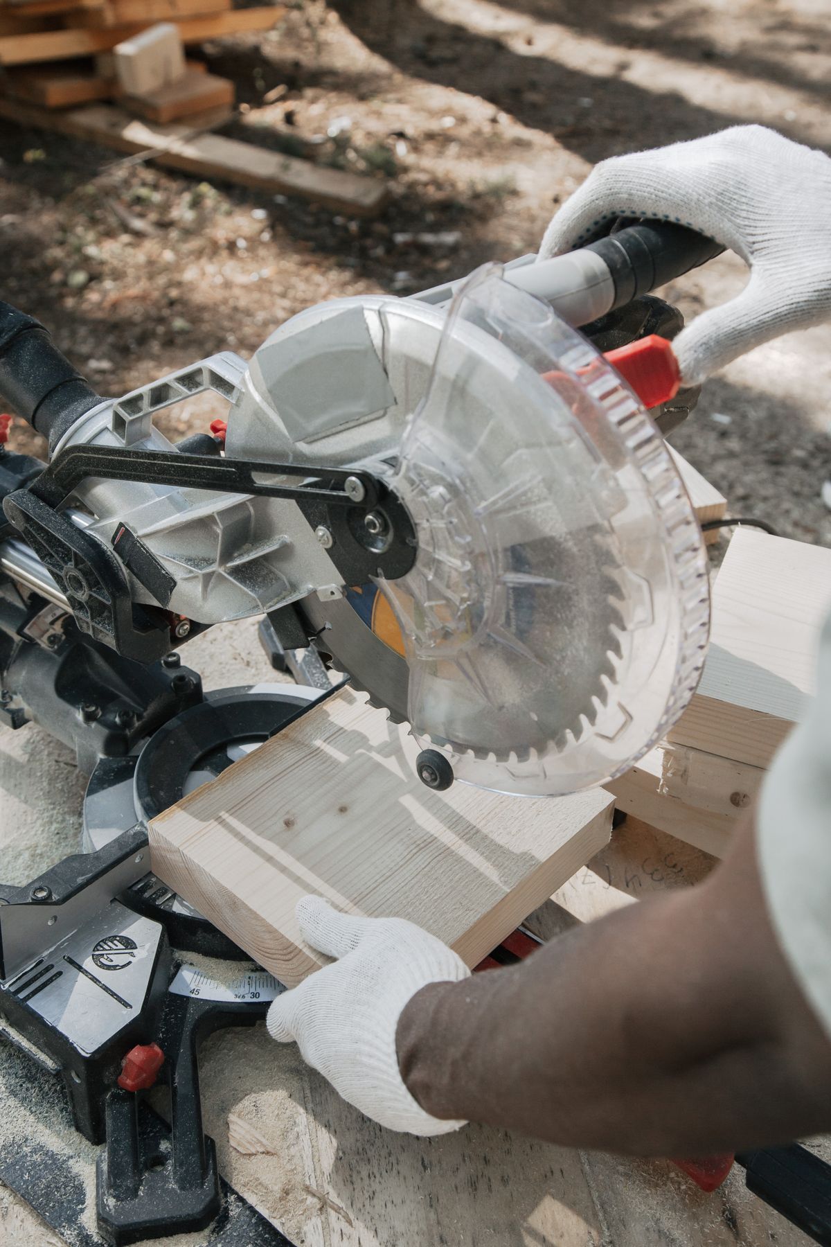 Carpenter cutting wood outdoors with a circular saw