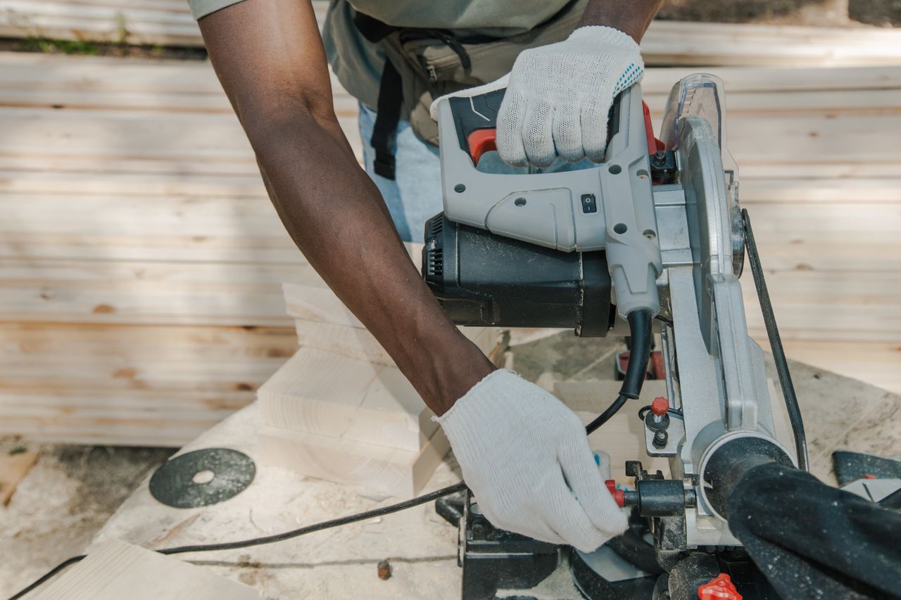 a worker uses a circular saw to cut wood outdoors showcasing skillful