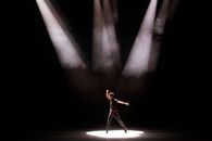 Woman in Red Dress Standing on Stage