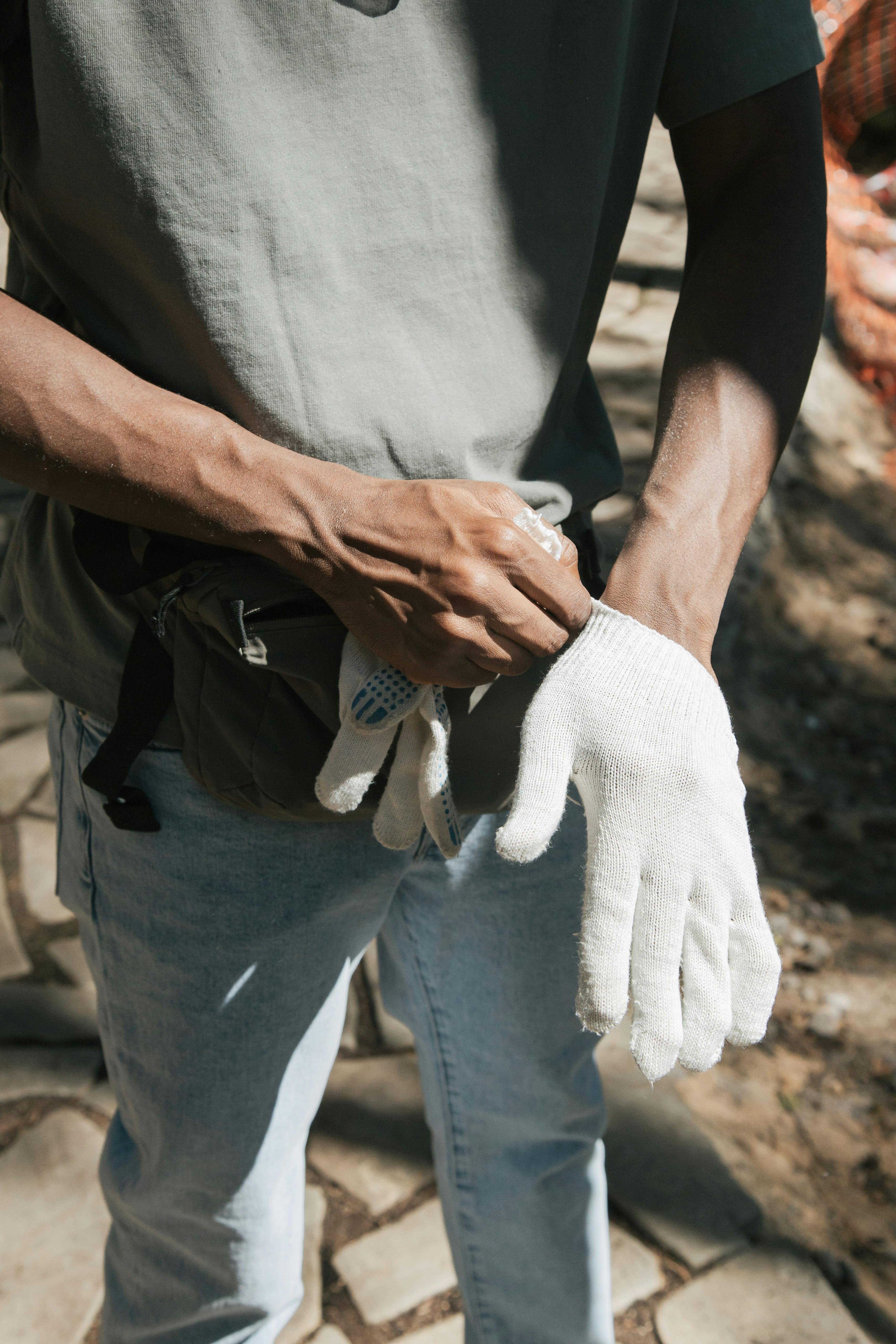 A CloseUp Shot of a Man Wearing Cotton Gloves · Free Stock Photo