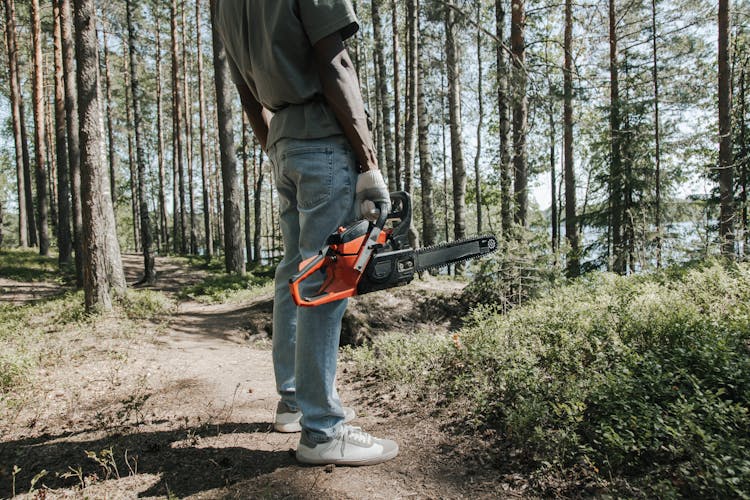 A Person Holding Chainsaw