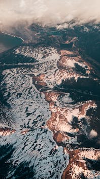 A breathtaking aerial shot of snow-capped mountain ranges showcasing nature's beauty.