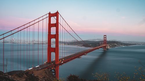 Free Stunning long exposure shot of the Golden Gate Bridge at dusk with a vibrant sky. Stock Photo