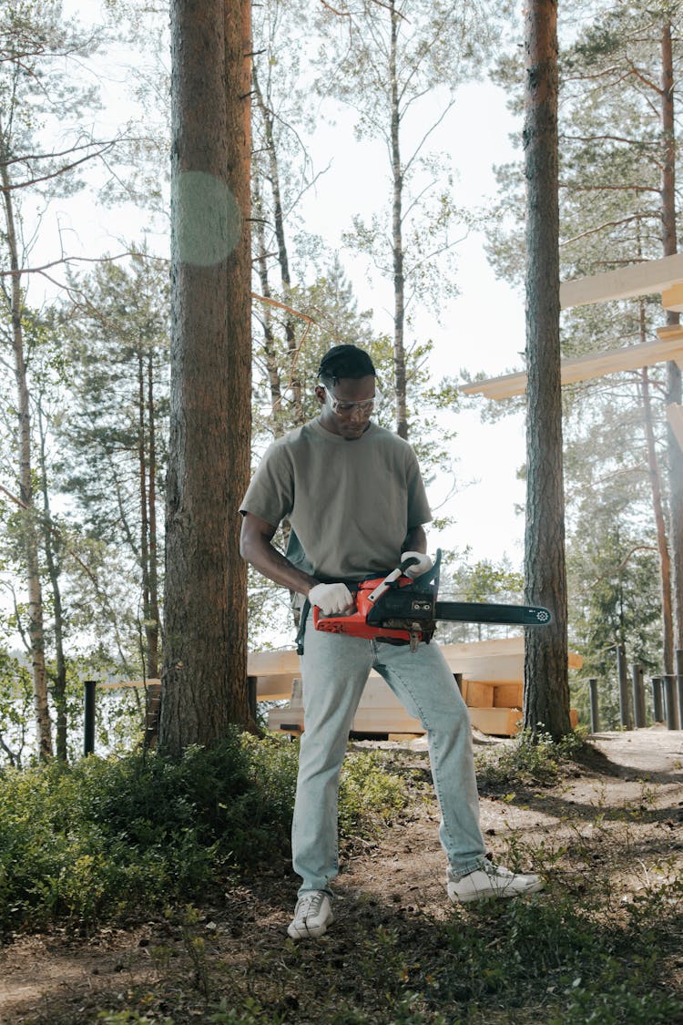 A Man Holding A Chainsaw