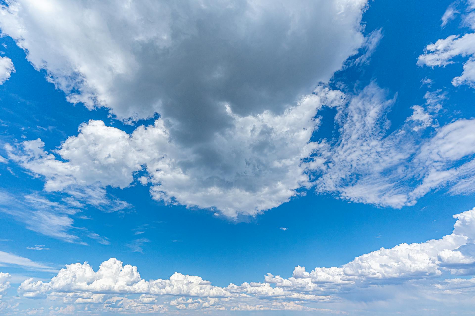 A breathtaking view of fluffy white clouds against a vibrant blue sky, perfect for backgrounds.