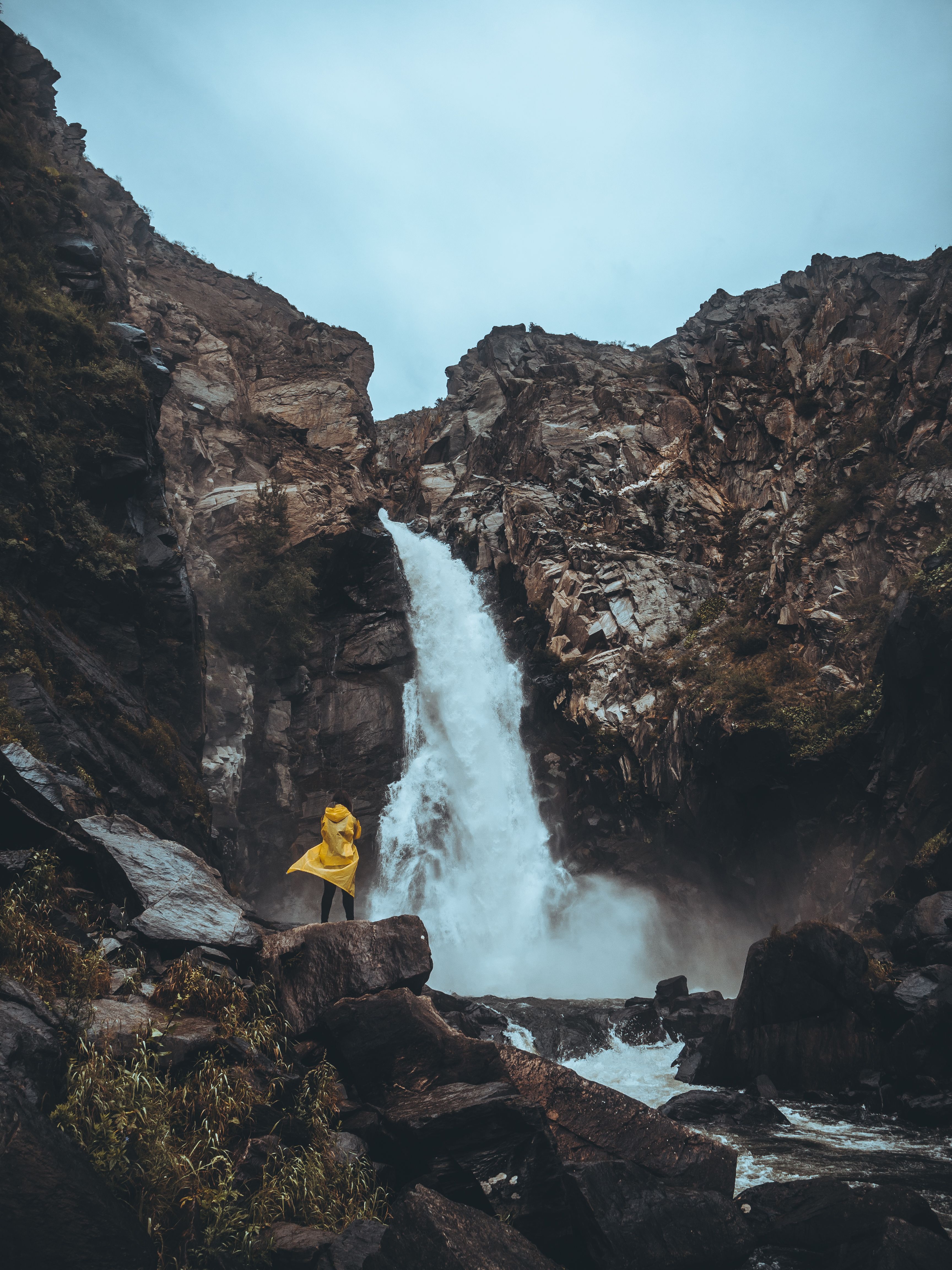 A Person Standing on a Rock with a View of a Beautiful Waterfall · Free ...