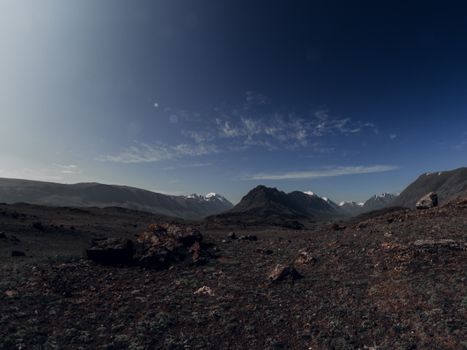 Scenic view of Altai Mountains in Russia with rocky terrain under a clear blue sky.