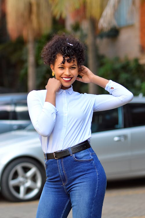 Free 
A Woman Wearing a White Long Sleeves Shirt and Denim Pants Stock Photo
