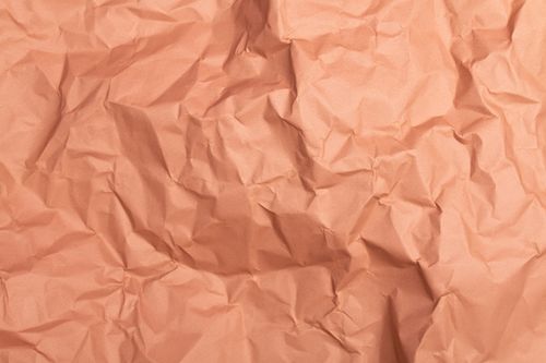 Free Close-up of crumpled pink paper texture, perfect for backgrounds and design projects. Stock Photo