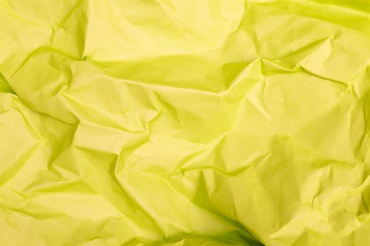High-quality close-up of crumpled yellow paper texture, perfect for background designs.