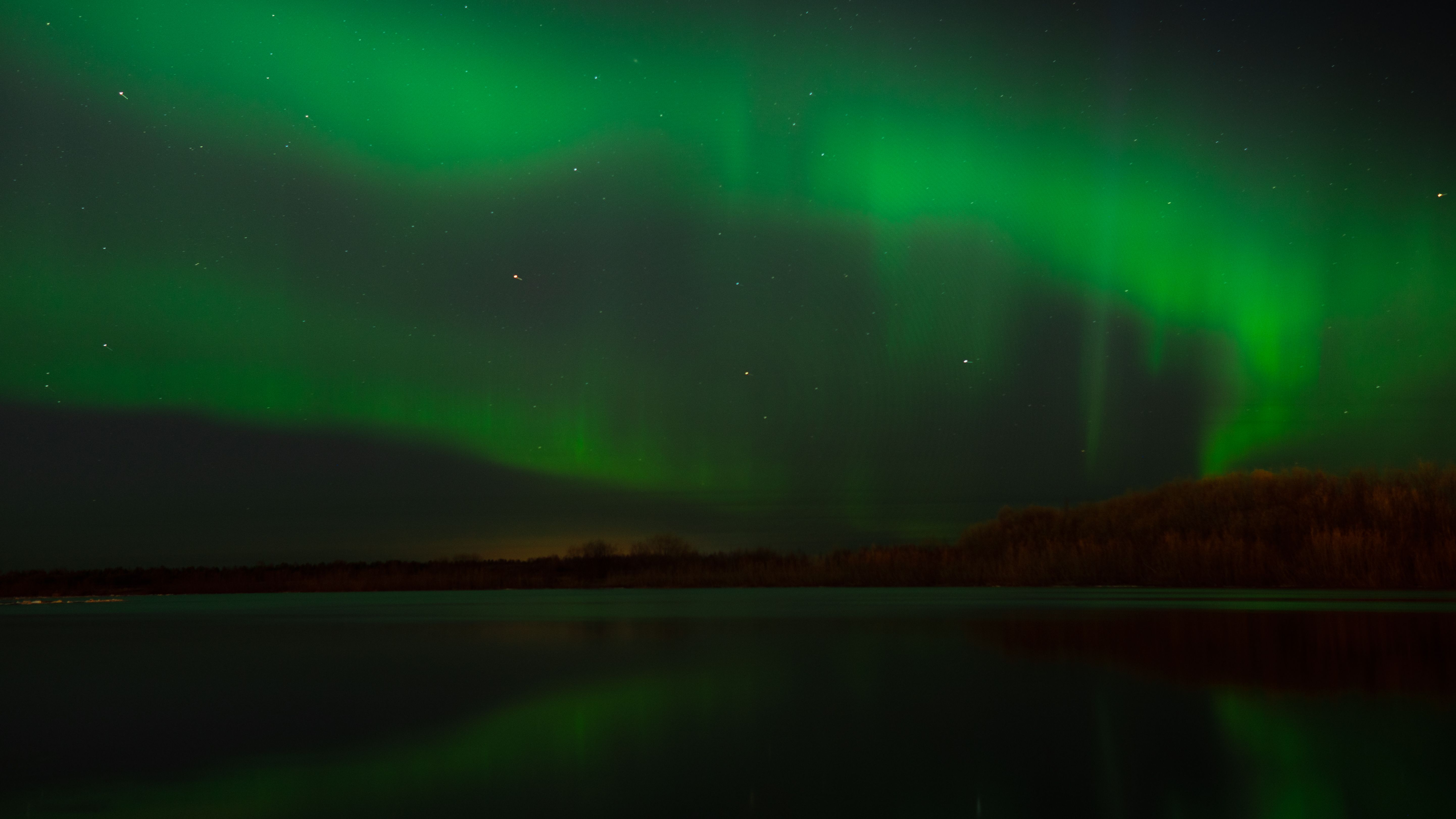 A View of the Aurora Borealis over a Lake at Night · Free Stock Photo