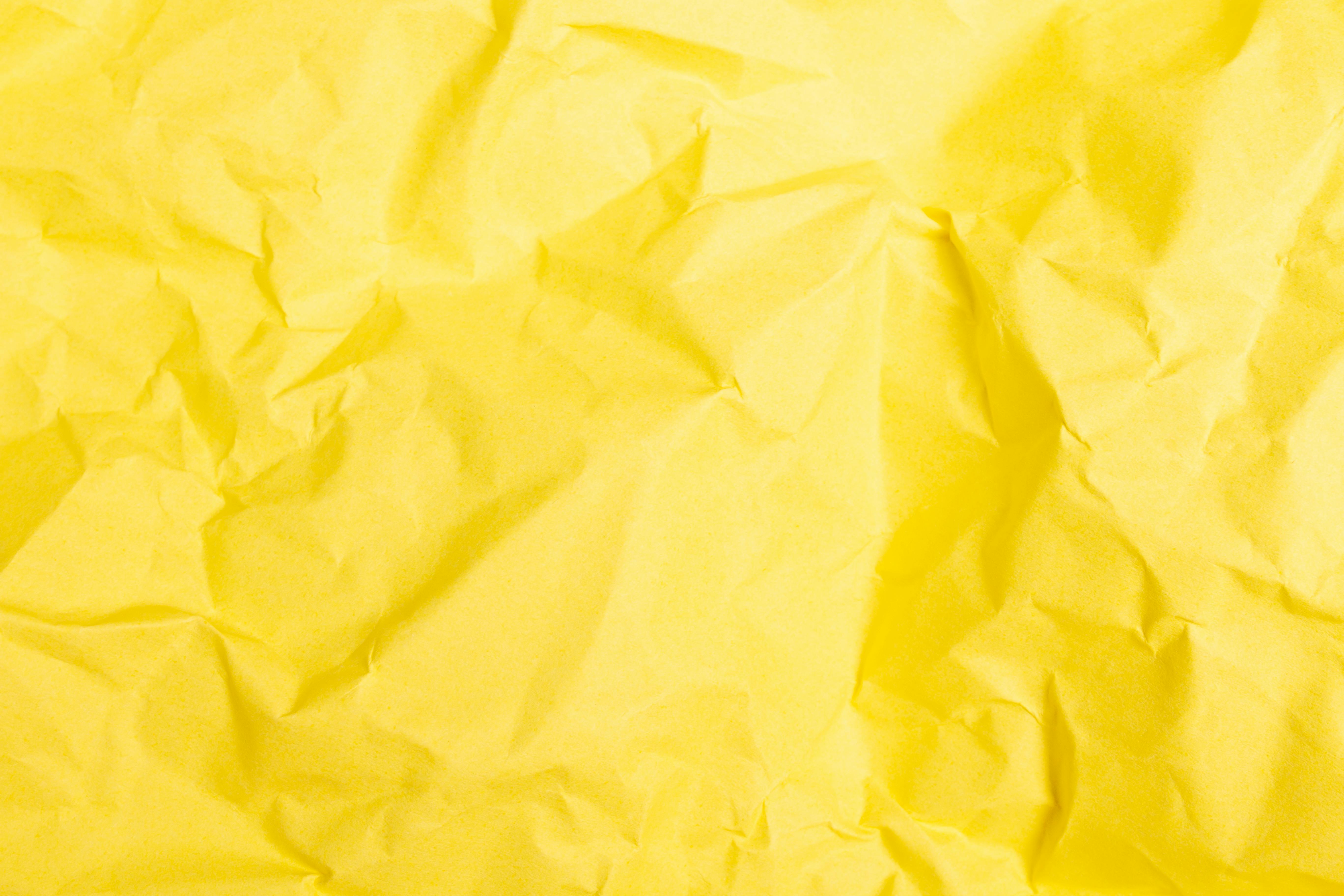 Premium Photo  Close-up crumpled yellow paper background