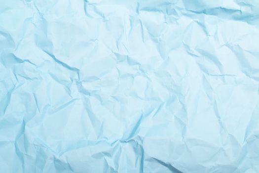 Close-up of a light blue crumpled paper texture, perfect for copy space or backgrounds.