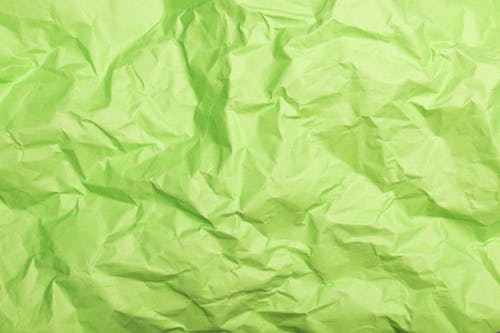 

A Close-Up Shot of a Crumpled Green Paper