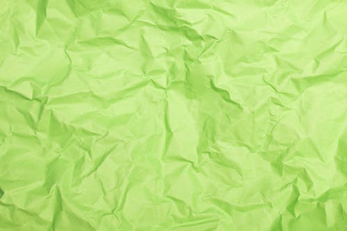 

A Close-Up Shot of a Crumpled Green Paper