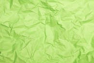 A Close-Up Shot of a Crumpled Green Paper