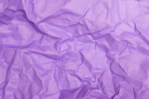 Close-up of crumpled purple paper creating a textured abstract background.