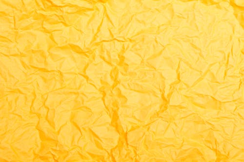 
A Close-Up Shot of a Crumpled Yellow Paper
