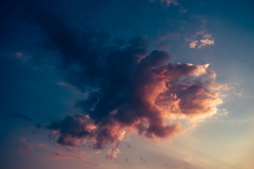 Free A dramatic cloudscape captured during sunset, showcasing vibrant and warm hues against a serene sky. Stock Photo