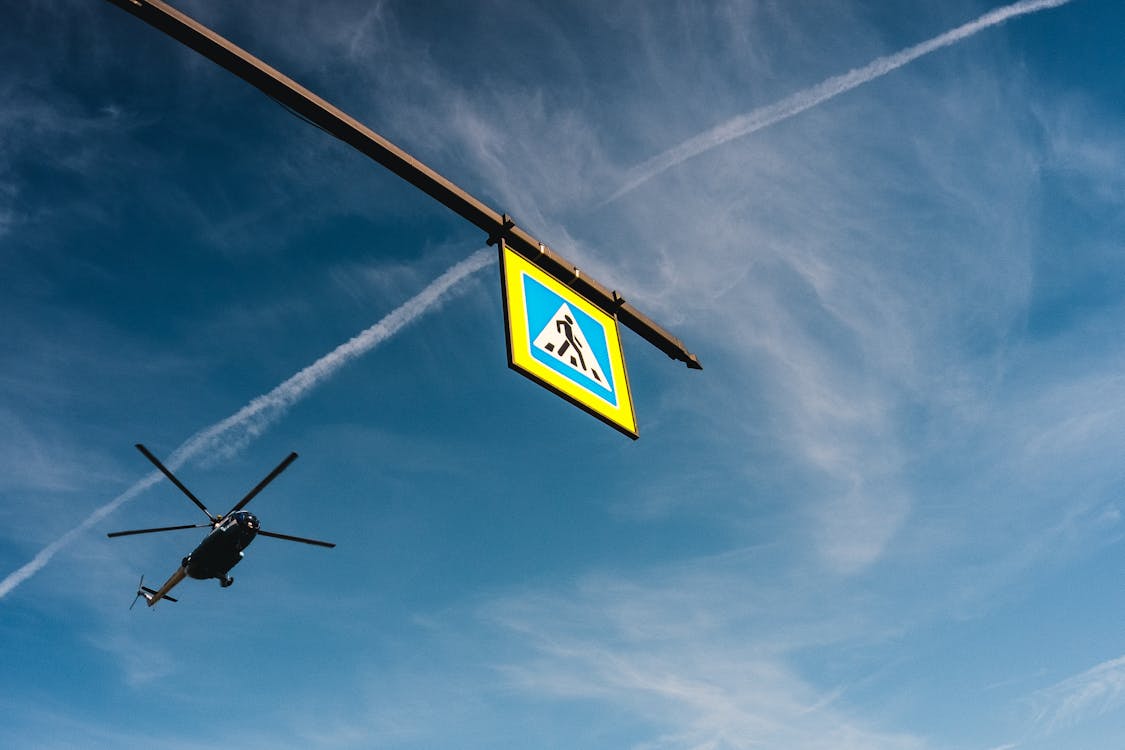 Yellow hanging Signage on a Metal Rail 